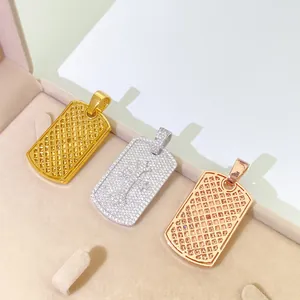 Macro detail of three S925 silver hip hop dog tag pendants in gold, silver and rose gold