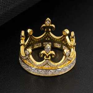Detailed macro view of a golden crown-shaped ring with sparkling moissanite stones