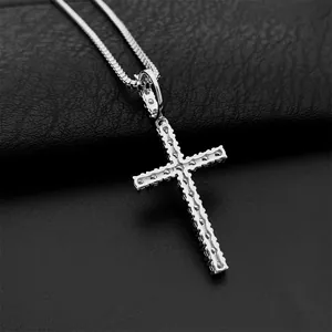 Detailed macro view of a 925 sterling silver iced out moissanite cross pendant necklace