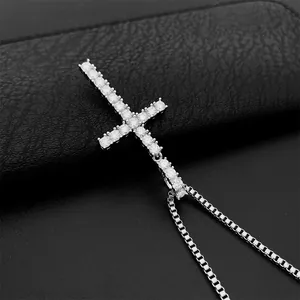 Close-up detail of 925 sterling silver cross pendant necklace set with D-color moissanite.