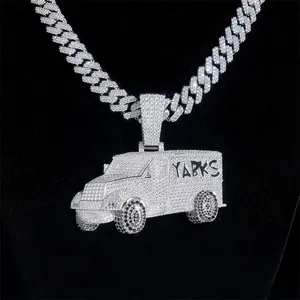 Detailed macro shot of iced out VVS Moissanite truck pendant on a silver Cuban link chain
