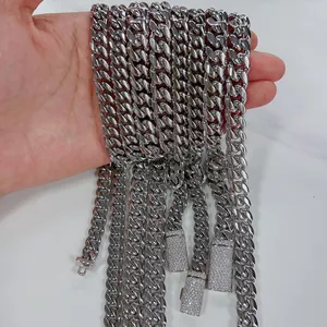 Close-up of stainless steel Cuban link necklaces with shiny moissanite encrusted clasps