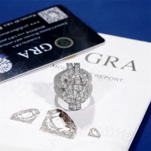 Detailed close-up of iced out moissanite dollar sign ring on GRA certificate background