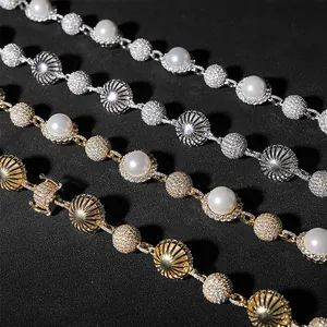 Detailed macro shot of luxury hip-hop pearl necklaces featuring pavé-set moissanite beads