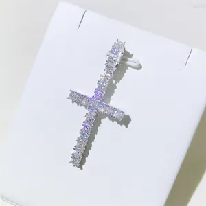 Detailed macro view of 3mm D color moissanite cross pendant in 925 silver