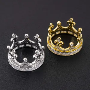 Detailed view of exquisite gold and silver crown-shaped rings with sparkling moissanite stones