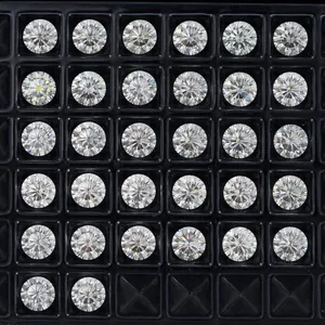 Close-up macro view of round moissanite stones neatly arranged in a black display grid tray