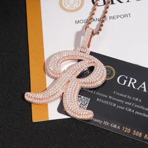 Close-up of iced out letter R pendant with Moissanite stones and GRA certificate