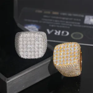 Close-up of gold and silver hip-hop square rings paved with brilliant moissanite stones