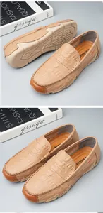 Detail view of the crocodile embossed texture and flexible soft sole on men's beige loafers