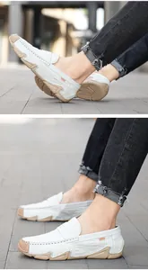 Close-up of white embossed leather loafers for men featuring anti-slip soft rubber soles