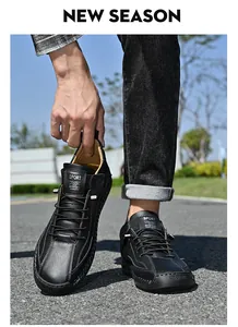 Detail view of black men's mid-top outdoor casual leather shoes with sporty accents