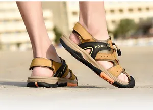 Side view of men's closed-toe beach sandals featuring anti-collision design on sand