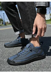 Detailed side view of blue men's mid-top slip-on casual leather shoes for outdoor wear