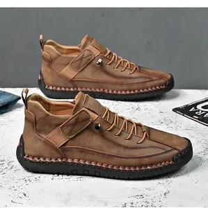 Side view of men's brown mid-top leather casual work boots with hand-stitched detail