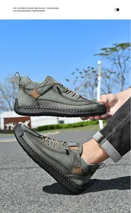 Detail view of men's green leather mid-top casual boots in an outdoor setting
