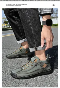 Close-up of men's casual mid-top leather boots in dusty green on an outdoor model