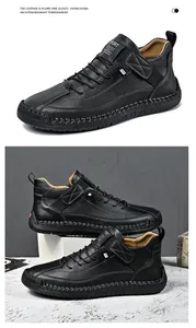 Close-up detail of black mid-top leather casual work boots with hand-stitched rubber soles