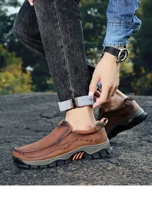 Close-up of brown leather outdoor slip-on loafers for men shown on rocky ground