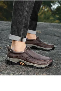 Detailed macro view of men's brown leather slip-on outdoor casual shoes on feet