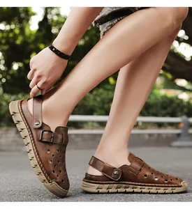 Close-up detailed side view of brown leather hollow-out men's dual-wear beach sandals.