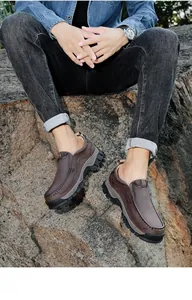 Close-up view of men's brown leather slip-on loafers for outdoor casual wear on a model