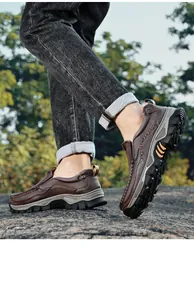 Men's brown leather outdoor slip-on loafers with rugged anti-slip soles shown in use outdoors.
