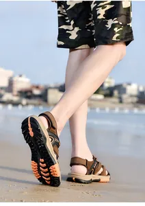 Durable men's outdoor beach sandals featuring anti-slip rubber soles on sandy terrain