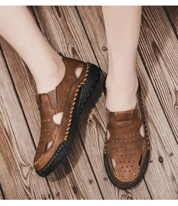 Top view of men's brown hollow-out leather sandals with handmade stitching details