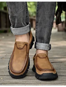Gros plan de mocassins pour hommes en cuir marron véritable sur un chemin en bois