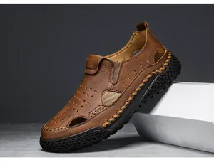 Detail shot of brown leather breathable handmade men's sandals with hollow design.