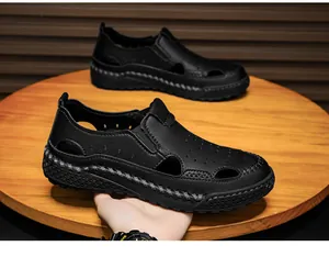 Close-up of men's breathable black leather hollow-out summer sandals with thick sole.