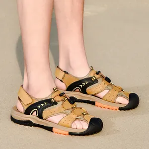 Comfortable men's khaki closed-toe beach sandals featuring anti-slip soles on sand