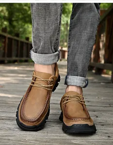 Gros plan de mocassins en cuir de vachette marron pour hommes sur chemin de bois