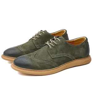 Detail view of men's olive green suede wingtip Brogue shoes with black toe.