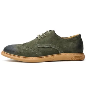 Side profile view of green suede brogue dress shoe with perforated wingtip detail