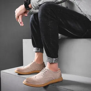 Detailed side view of men's tan suede Brogue shoes with classic perforated detailing
