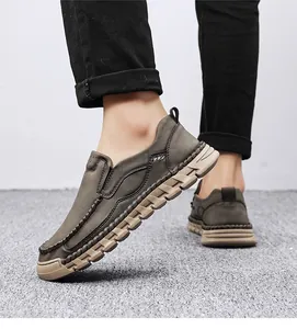 Detail view of men's casual slip-on loafers with hand-stitched moc-toe and soft sole