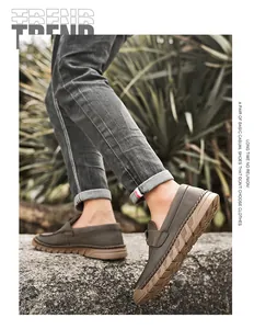 Detailed side view of men's olive green leather loafers with durable rubber soles.