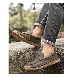 Detailed shot of retro handmade men's leather loafers with soft soles in outdoor setting