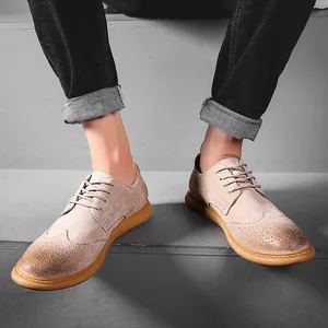 Close-up of beige genuine leather Brogue shoes with vintage texture on concrete stairs