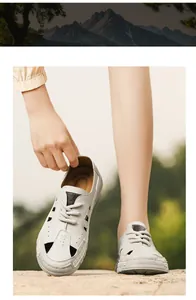 Detail of breathable white leather hollow-out beach sandals for men in outdoor setting.