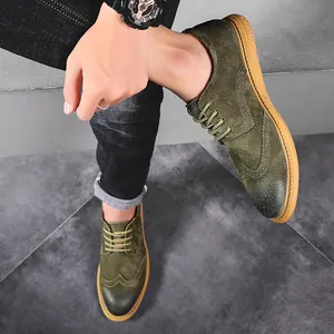 Detailed view of green suede men's Brogue shoes with classic perforated details