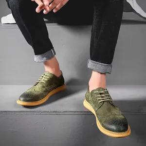 Detailed view of olive green suede Brogue shoes with wingtip perforations for men.