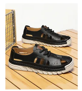 Detailed view of breathable black leather men's cutout beach sandals on a wood surface.
