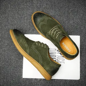 Men's olive green suede brogue shoes with classic wingtip detailing and rubber sole.