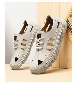 Detailed view of white breathable hollow-out men's summer beach sandals with soft soles.