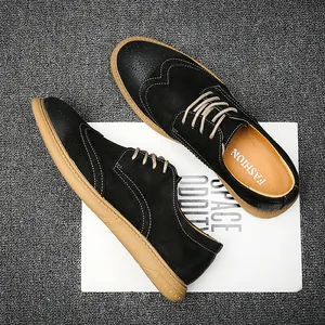 Black leather Brogue shoes for men with wingtip perforation and tan rubber soles