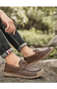 Close-up of men's brown vintage leather loafers featuring soft sole and slip-on design