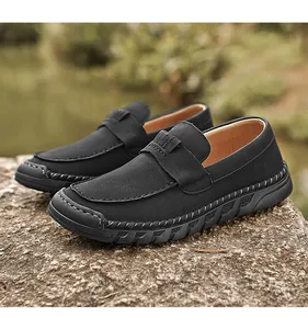 Close-up of men's black loafers with retro hand-stitched seams and premium textured leather